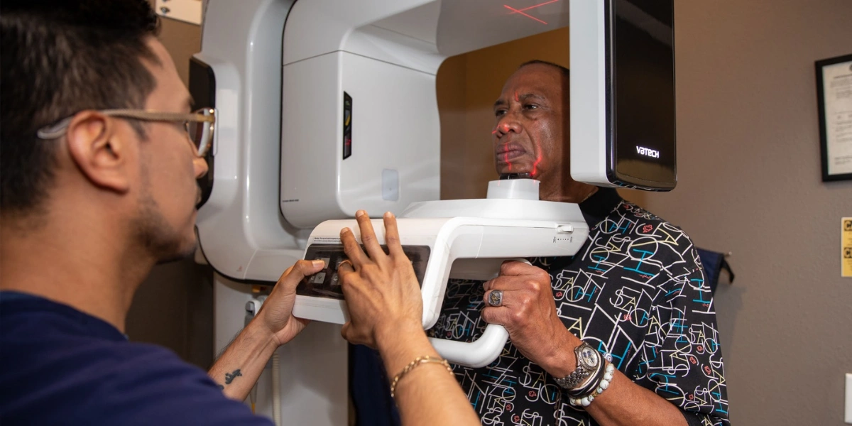 Patient undergoing 3D dental scan to evaluate jawbone for dental implants in Houston dental office