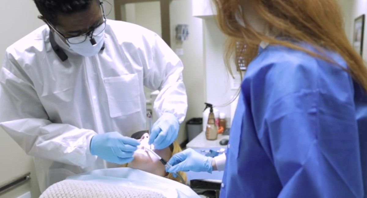 Dr. James Amaning and team providing dental implant treatment at Amazing Dental Solutions in Houston.