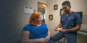 Dr. James Amaning discussing dental implant treatment options with a patient at Amazing Dental Solutions in Houston.