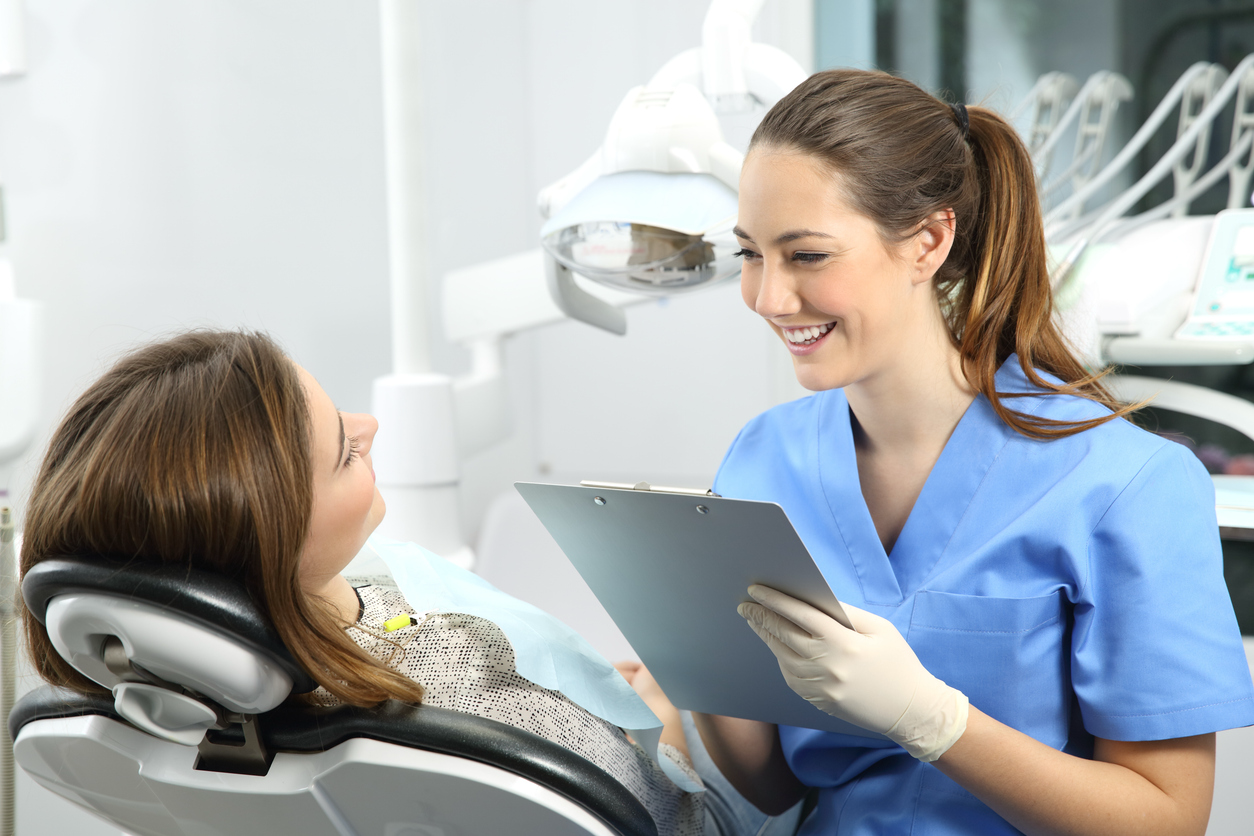 Young adult discussing wisdom tooth concerns with a dental professional during a consultation.
